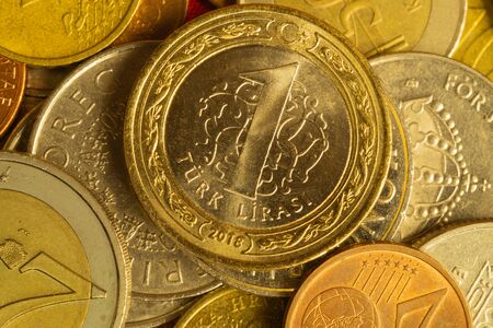 Coins of different countries. a lot of metal coins of different denominations and various countries. financial background. turkish lira in the foregroundの写真素材