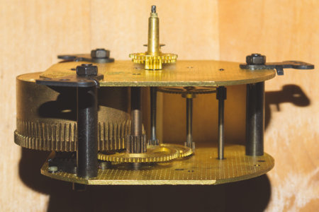 Clock mechanism on wooden table. detail of gears of a mechanical watch