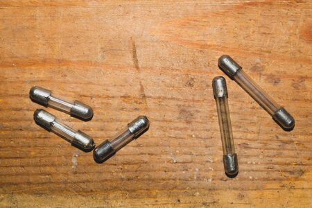 Fuse on wooden background. safety device for overcurrent protection. protection of an electrical circuitの写真素材
