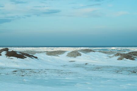 Blue frozen lake with the sky. winter landscape. nature background with a horizon lineの写真素材