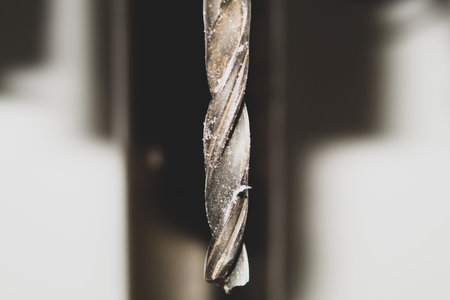 Drill bit of a drilling machine close up. working tool background