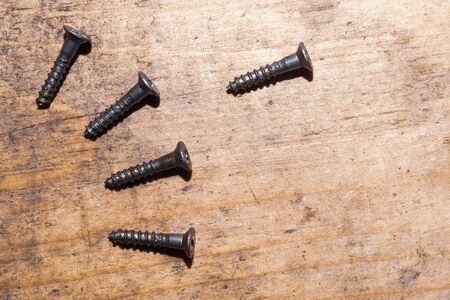 Screws on a wooden background.working tools. copy spaceの写真素材