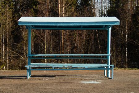Rural bus stop on the country road with the forest on the backgroundの写真素材