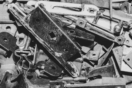 Pile of fasteners and screws close up. scrap metal. different metal partsの写真素材