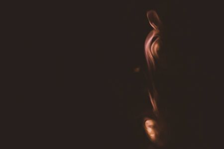 Colored smoke on black backdrop. brown fog abstract backgroundの写真素材