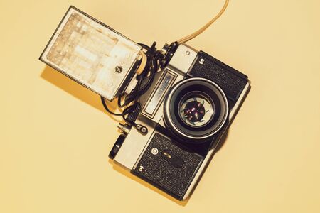 Vintage camera on yellow background. copy spaceの写真素材