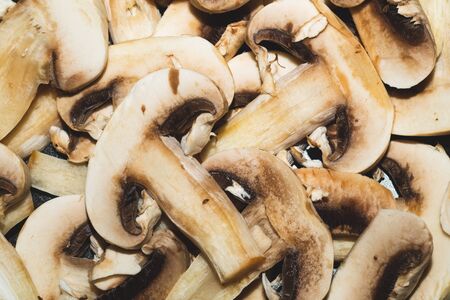 Sliced mushrooms. background with champignons. healthy food. vegetarian nutrition. cooking processの写真素材