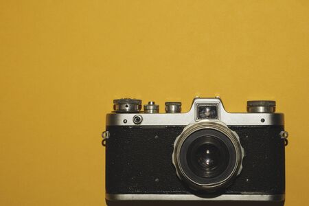 Vintage camera on yellow background. copy spaceの写真素材