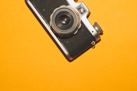 Vintage camera on yellow background. copy space