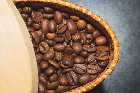 Coffee beans in a bark container. roasted coffee beans in a wooden jarの写真素材