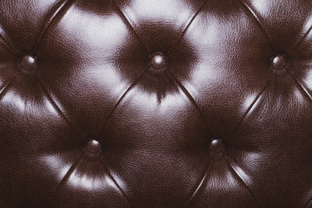 Leather upholstery texture of sofa. brown luxury couch close up backgroundの写真素材