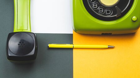 Classic phone with handset. pen with a note. office background. vintage green telephone with phone receiver. old communication technology. copy spaceの写真素材