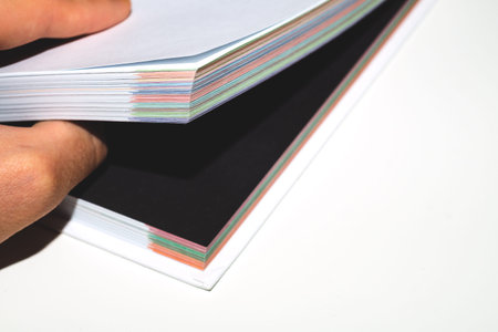 Book is open on a black page. colorful book edge close up. copy space