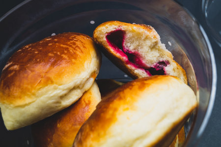 Buns with red jam in a glass jar. sweet foodの写真素材