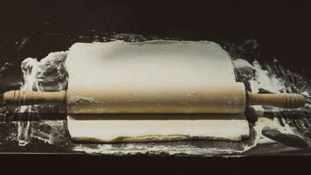 Dough with rolling pin and flour. homemade pizza base preparingの写真素材