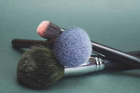 Makeup brushes on colored background. various cosmetic brushes close up. skin care accessories