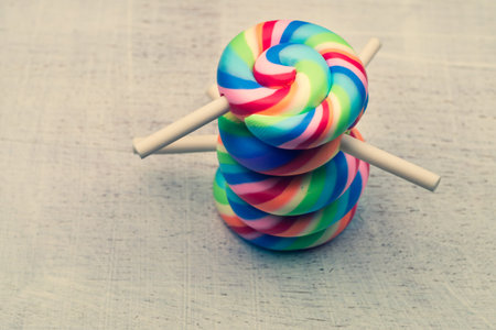Lollipops on a wooden background. colorful candies close up. copy spaceの写真素材
