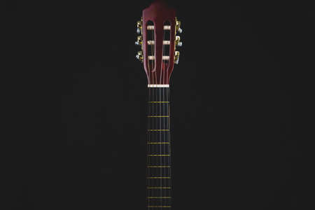 Guitar fretboard on black background. acoustic musical instrument. copy spaceの写真素材