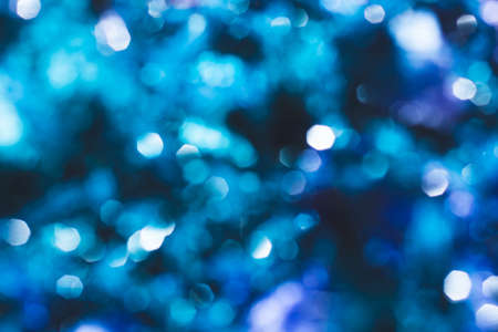 Blue festive background with bokeh lights. blurred lights glowingの写真素材