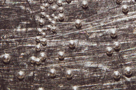 Boiling water bubbles close up. abstract texture with water drops on steel plate. gray rough backgroundの写真素材