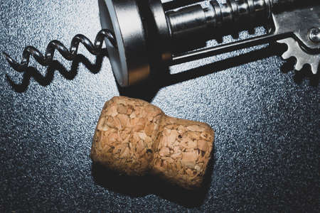 Wine cork and corkscrew on the table close upの写真素材