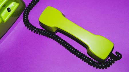 Telephone handset. phone receiver on purple background. old communication technology. copy spaceの写真素材