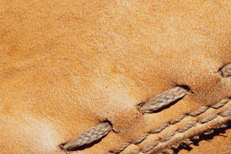 Brown leather texture with a stitch. material with seam macro backgroundの写真素材