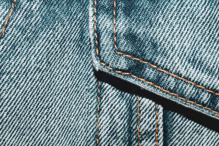 Jeans background with seams. denim texture close up. fabric backdrop with stitchesの写真素材