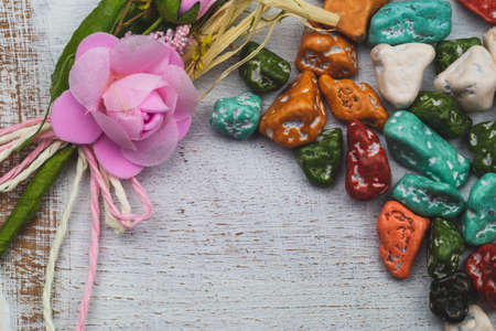 Festive decoration. candy pebbles. sweets in the form of colored stones. wooden background with colorful candies. copy spaceの写真素材