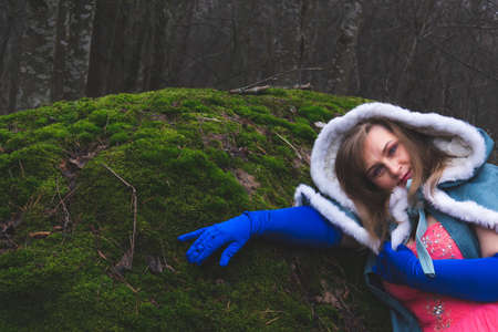 Woman with a mantle in the forest. adult woman in fantasy costume with capeの写真素材