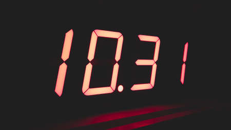 Digital clock with red led light illumination numbers in the dark. electronic timer with digits 1031の写真素材