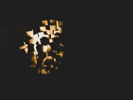 Wooden cubes stack with light shines in the dark. abstract structure with squared blocksの写真素材