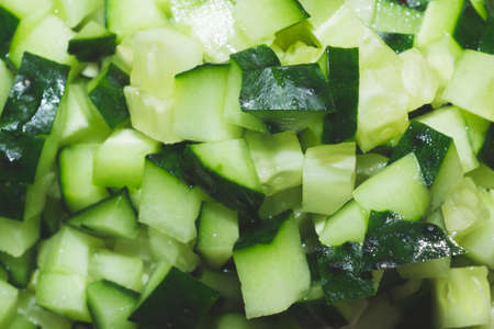 Cucumber pieces close up. Salad ingredient. Vegetable backgroundの写真素材