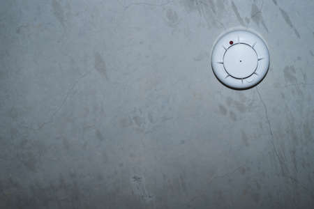 Smoke detector on concrete ceiling. fire protection system close upの写真素材