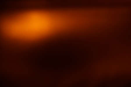 Abstract brown background. Golden light shines in the darkの写真素材