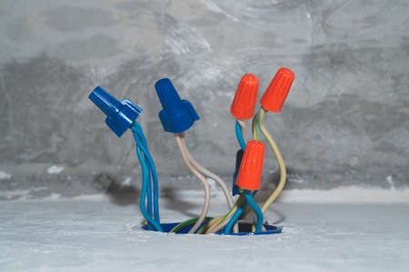 Unfinished electrical socket with electrical wires and connectors. renovation processの写真素材