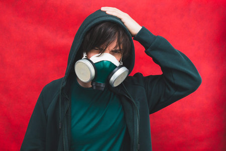 Man in respirator mask on red background. male portrait in gas mask. pollution concept
