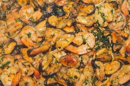 Fried prawns and mussels. grilled seafood close up. cooking processの写真素材