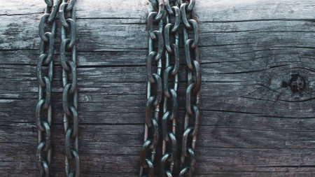 Metal chain on wooden wall backgroundの写真素材