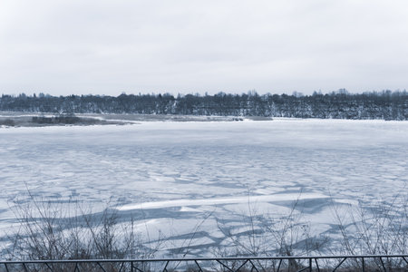 Frozen river with cracked ice. cold weatherの写真素材