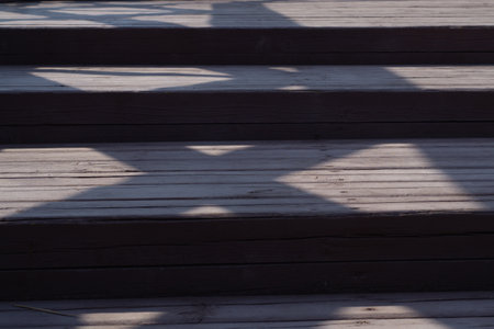 Wooden staircase with shadows close upの写真素材