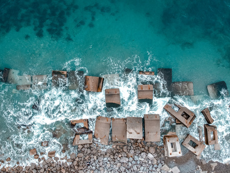 Waves hitting stones in the waterの写真素材