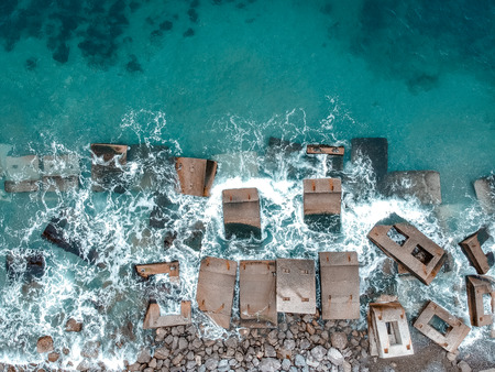 Waves hitting stones in the waterの写真素材