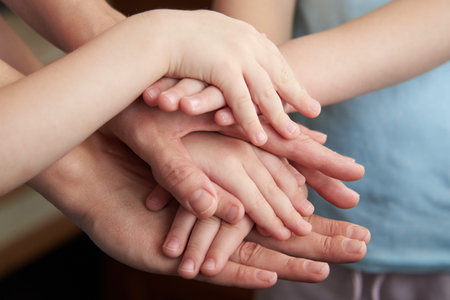 People putting hands together, closeup. Unity concept