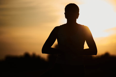 silhouette of a woman doing yoga in the fresh air. The concept of a healthy lifestyle. Outdoor...