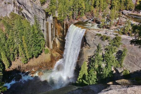 Stunning Vernal Fall at Yosemite National Park with viewing platform. From the size of the people on the viewing platform you can see how massive the waterfall is.の写真素材