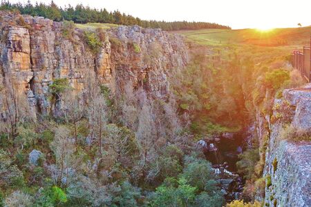 Beautiful sunset over the cliffs of Gods Window in South Africaの写真素材