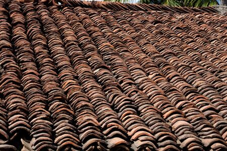 old brown tiles on the roof of the homeの写真素材