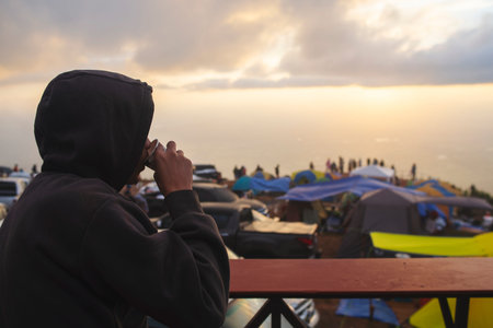 Man sipping coffee at sunset, On the balcony, Camping area, In the winter.
