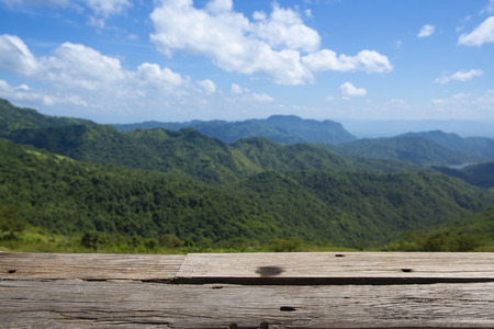 Wooden table top with mountain landscape.の写真素材
